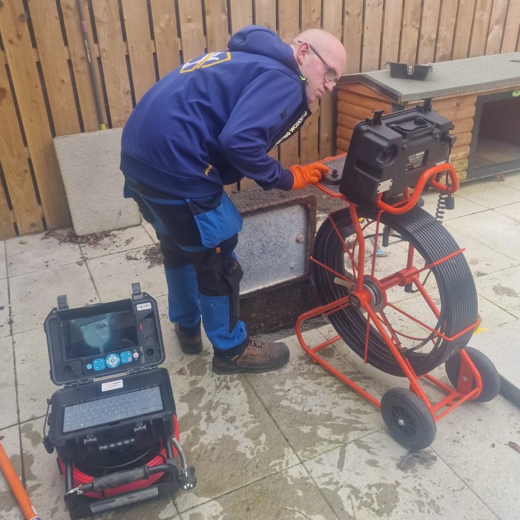 Drain technician reviewing CCTV footage during a drain survey